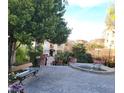 Community courtyard featuring a bench, fountain, and lush landscaping at 30 Strada Di Villaggio # 631, Henderson, NV 89011