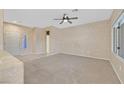 Spacious living room with tile entrance, carpeted area, neutral walls and a ceiling fan at 3051 Scotts Valley Dr, Henderson, NV 89052