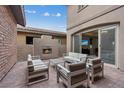 Outdoor patio with comfortable seating and a cozy brick fireplace for relaxing and entertaining at 342 Molinetto St, Las Vegas, NV 89138