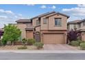 Charming two-story home with a brick-accented facade, a paved driveway, and a well-manicured front yard at 342 Molinetto St, Las Vegas, NV 89138