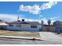 Street view of a single story home with a spacious front yard and an extended driveway at 3749 Ponderosa Ave, Las Vegas, NV 89115