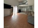 Bright living room featuring tile floors, large windows, a sofa and media center at 3813 Marshall Cir, Las Vegas, NV 89108