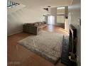 Bright living room featuring tile floors, fireplace and a large sofa at 3813 Marshall Cir, Las Vegas, NV 89108