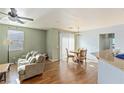 Inviting living room and dining area featuring hardwood floors, a ceiling fan, and plenty of natural light at 4350 Westbury Square St # 3, North Las Vegas, NV 89032
