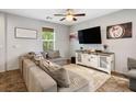 Cozy living area showcasing a comfortable grey sectional sofa and a stylish media console beneath a wall-mounted television at 4610 Lime Straight Dr, Las Vegas, NV 89115
