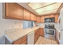 Well-lit kitchen with stainless steel appliances and wooden cabinetry at 5068 Jeffreys St # 202, Las Vegas, NV 89119