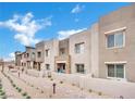 Modern townhouse with neutral colors, stone accents, and manicured landscaping at 600 N Carriage Hill Dr # 1008, Las Vegas, NV 89138