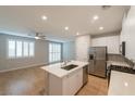Bright kitchen with island, stainless steel appliances, modern cabinets, and lots of natural light at 6145 May River St, Las Vegas, NV 89148