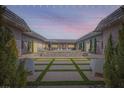 Captivating courtyard with stylish seating, elegant pavers, ambient string lights, and privacy at 647 Foxhall Rd, Henderson, NV 89002