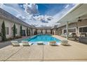 Sparkling pool with lounge chairs and covered patio, perfect for relaxing and entertaining at 647 Foxhall Rd, Henderson, NV 89002