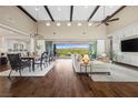 Spacious living room with hardwood floors, a high ceiling, and access to the backyard at 6700 Regency Stone Way, Las Vegas, NV 89148