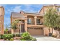 Charming two-story home boasts a front-facing balcony, tile roof, and a two-car garage in a landscaped community at 6843 Philharmonic Ave, Las Vegas, NV 89139