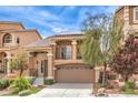 Inviting two-story home with a balcony, a 2-car garage, desert landscaping, and energy-efficient solar panels at 6843 Philharmonic Ave, Las Vegas, NV 89139