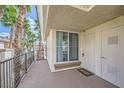 Balcony view with palm trees, leading to the front door and storage at 7151 S Durango Dr # 312, Las Vegas, NV 89113
