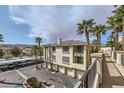 Desert property shows attractive condo buildings with garages and desert landscaping, set under dramatic skies at 7151 S Durango Dr # 312, Las Vegas, NV 89113