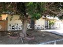A single-story home featuring stone accents and a mature tree providing shade at 725 Miller Ave, North Las Vegas, NV 89030
