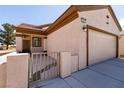 Well-maintained single-Gathering home with a two-car garage, desert landscaping, and a private gated front porch at 7824 Pine Warbler Way, North Las Vegas, NV 89084