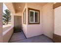 Charming front porch with a secure gate, offering privacy and curb appeal to this lovely home at 7824 Pine Warbler Way, North Las Vegas, NV 89084