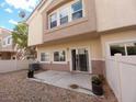The backyard features a patio area, a gravel landscape, and a secure fence at 8664 Traveling Breeze Ave # 102, Las Vegas, NV 89178