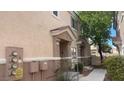 Inviting townhouse exterior with a small porch and well-maintained landscaping at 8664 Traveling Breeze Ave # 102, Las Vegas, NV 89178