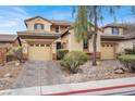 Charming two-story home featuring a dual garage, desert landscaping, and a welcoming facade with neutral color palette at 9049 Teetering Rock Ave, Las Vegas, NV 89143