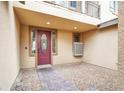 Inviting entrance featuring a decorative red door, stylish sidelights, and a welcoming brick path, blending elegance and charm at 9049 Teetering Rock Ave, Las Vegas, NV 89143