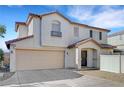 Two-story home featuring stucco siding, a two-car garage, and a well-manicured front yard at 9073 Spoonbill Ridge Pl, Las Vegas, NV 89143