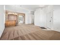 Spacious living room featuring carpet and a decorative bar area at 9211 Golden Feather Ct, Las Vegas, NV 89147