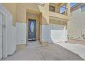 Inviting front entrance with a decorative oval glass door, a two-car garage, and a cozy balcony above at 9221 Steeltree St, Las Vegas, NV 89143