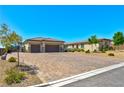 Stunning single story home featuring a three car garage and beautiful desert landscaping at 9511 Star Vista Ct, Las Vegas, NV 89149