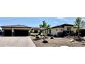 Inviting single-story home with a brick driveway, desert landscaping and garage at 9511 Star Vista Ct, Las Vegas, NV 89149
