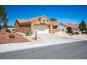 Single-story home with a two-car garage, desert landscaping, and a mailbox at 9536 Ruby Hills Dr, Las Vegas, NV 89134