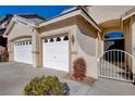 Close-up view of home's entry, highlighting three-car garage and gated entry at 9632 Cherry Canyon Ave, Las Vegas, NV 89129
