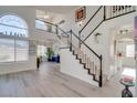 Inviting entryway with staircase, high ceilings, and plenty of natural light from large windows at 1100 Meridian Bay Dr, Las Vegas, NV 89128