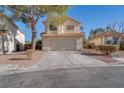 Charming two-story home with a well-maintained front yard and an attached two-car garage at 1100 Meridian Bay Dr, Las Vegas, NV 89128