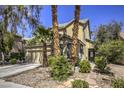 Beautifully landscaped home featuring rock details, lush shrubbery, and a well-manicured lawn at 11215 Piazzale St, Las Vegas, NV 89141