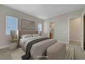 Staged main bedroom features plush carpet, natural light, and a large walk-in closet at 11297 Essence Point Ave # 102, Las Vegas, NV 89135