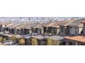 View of houses in the community featuring roofs with solar panels and a background of mountains and the city skyline at 11756 Emerald Lake Ave, Las Vegas, NV 89138