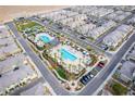 Aerial view of a community with a swimming pool, palm trees, a park, and townhomes at 12108 Harvest Sky Way # 1, Las Vegas, NV 89183