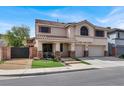 Charming two-story home featuring a tile roof, manicured landscaping, and a two-car garage at 1283 Peppercorn Ave, Henderson, NV 89012