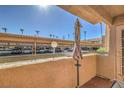 Balcony view overlooking covered parking and palm trees on a sunny day at 1375 E Hacienda Ave # 114, Las Vegas, NV 89119