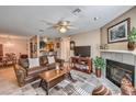 Cozy living room featuring a fireplace and comfortable leather furniture, with dining area beyond at 1375 E Hacienda Ave # 114, Las Vegas, NV 89119