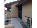 Home's entry with a secure door, window, and stucco exterior at 1732 Yellow Rose St, Las Vegas, NV 89108