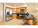 Well-equipped kitchen with stainless steel appliances, ample cabinetry, and black countertops at 211 E Flamingo Rd # 714, Las Vegas, NV 89169