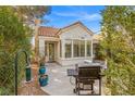 Backyard patio area showcasing a built-in grill and lush landscaping, ideal for outdoor dining at 2292 Cassatt Dr, Henderson, NV 89074