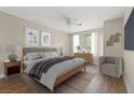 Serene bedroom with wood floors, a ceiling fan, and large windows providing ample natural light at 2292 Cassatt Dr, Henderson, NV 89074