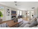 Bright living room featuring hardwood floors, built-in shelving, and a decorative fireplace with tile at 2292 Cassatt Dr, Henderson, NV 89074