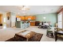 Open-concept living room with a spacious layout, kitchen and dining area, and a neutral color palette at 2388 Aztec Ruin Way, Henderson, NV 89044