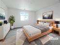 Bright bedroom with modern furnishings, soft rug, and large window for natural light at 3610 Tripoli Cove Ave, Las Vegas, NV 89106
