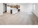 The open-concept layout is visible in this living room leading into a kitchen area with modern countertops at 3610 Tripoli Cove Ave, Las Vegas, NV 89106